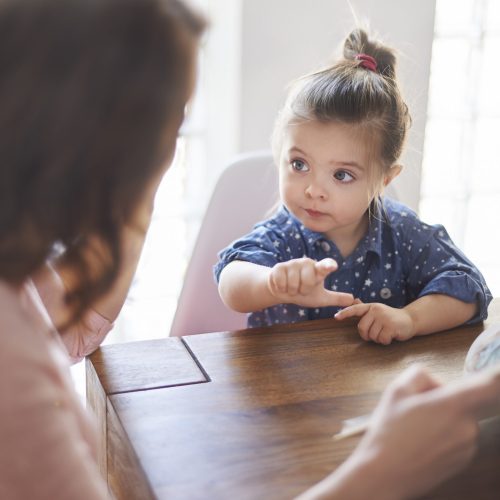 Cute girl with mom reading a book